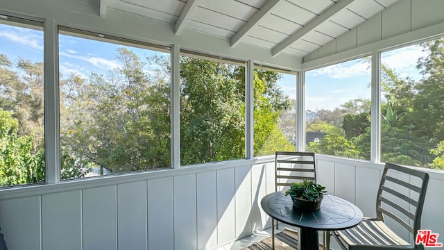 sunroom with lofted ceiling with beams and wooden ceiling