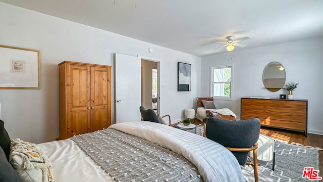 bedroom with ceiling fan and dark hardwood / wood-style floors