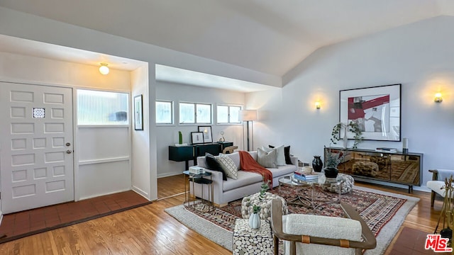 living room with hardwood / wood-style flooring and vaulted ceiling