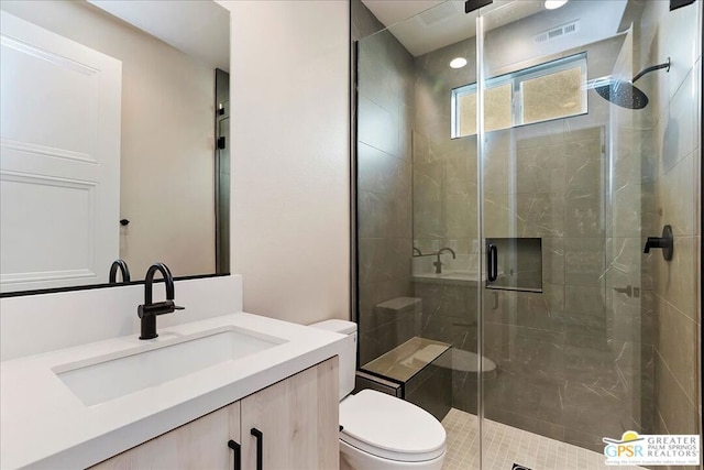 bathroom featuring vanity, toilet, and an enclosed shower