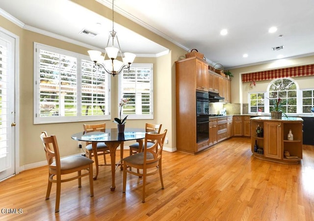 kitchen featuring ornamental molding, hanging light fixtures, backsplash, and a notable chandelier