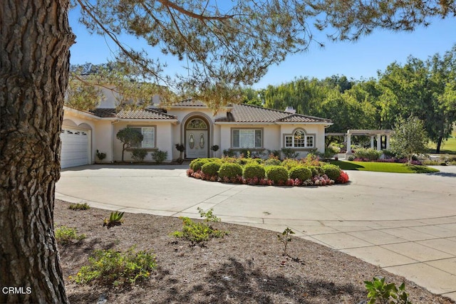 mediterranean / spanish-style house with a garage