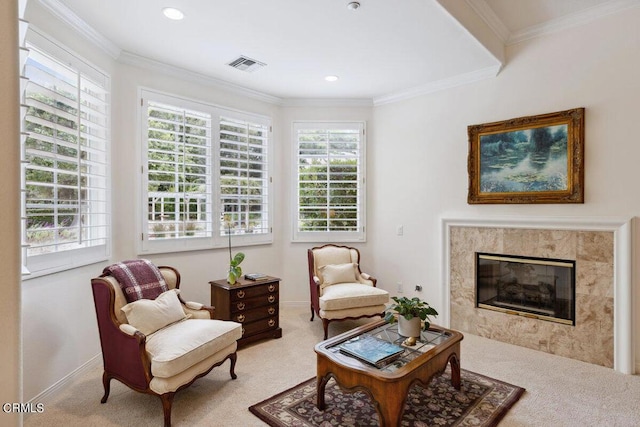 living area featuring a fireplace, ornamental molding, and light colored carpet