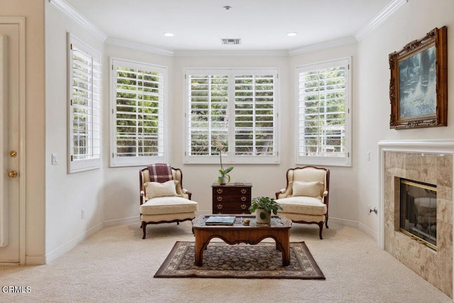 sitting room featuring a fireplace, ornamental molding, and carpet