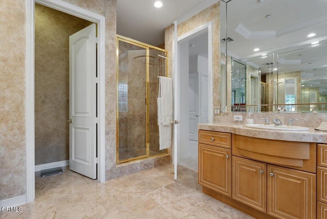 bathroom with vanity, crown molding, and a shower with shower door