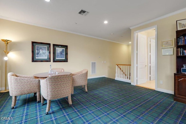 dining room with crown molding and dark carpet