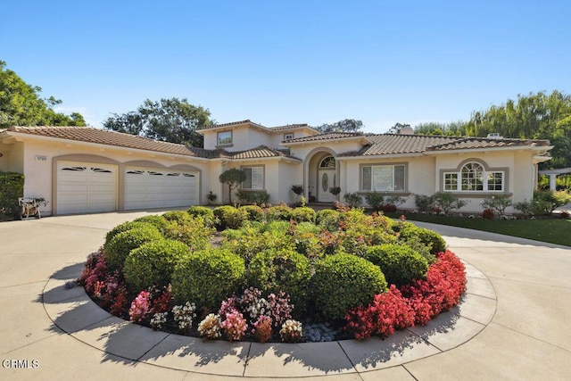 mediterranean / spanish-style home with a garage