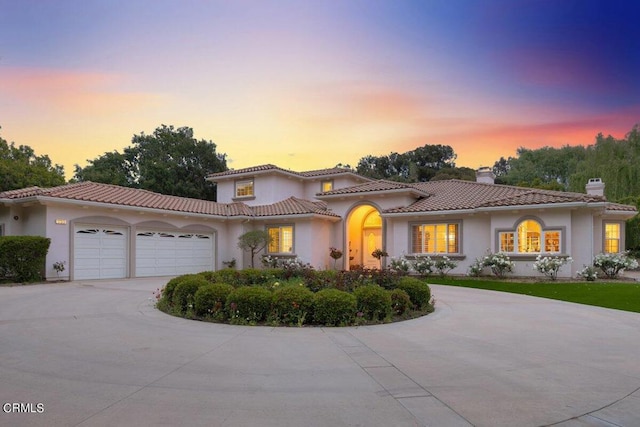 mediterranean / spanish home with a garage