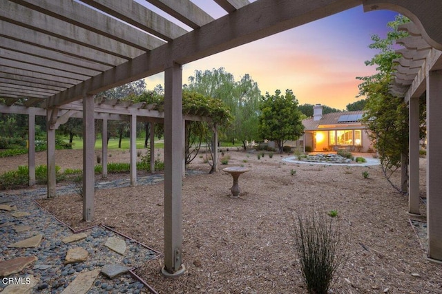 yard at dusk with a pergola