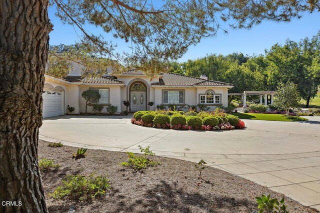 mediterranean / spanish home with a garage