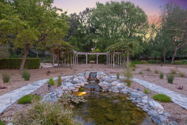 yard at dusk with a pergola