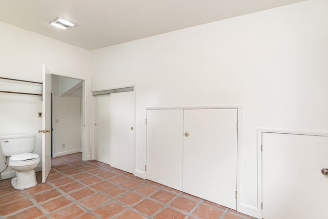 bathroom featuring tile patterned flooring and toilet