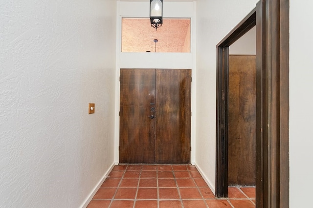 doorway to outside with tile patterned flooring