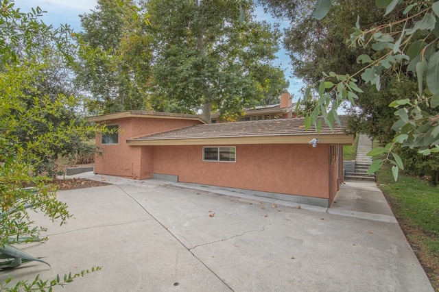 view of side of property with a patio