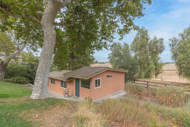 view of side of home featuring a yard