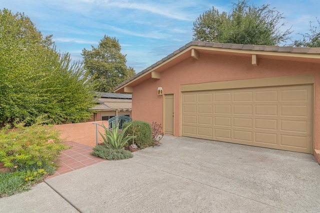 view of side of property with a garage