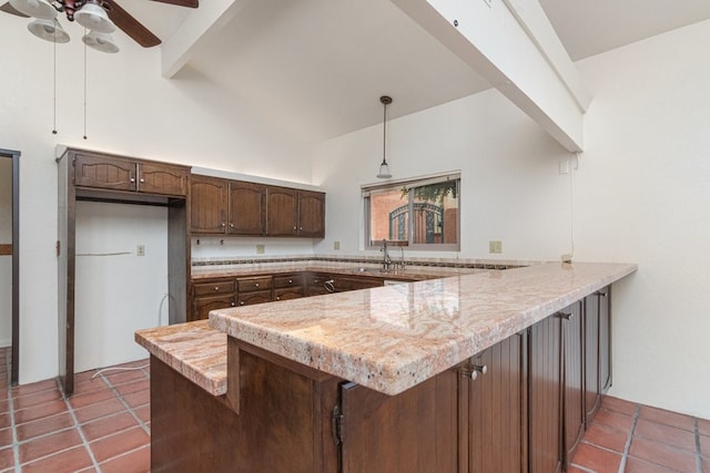 kitchen featuring kitchen peninsula, dark brown cabinetry, ceiling fan, high vaulted ceiling, and hanging light fixtures