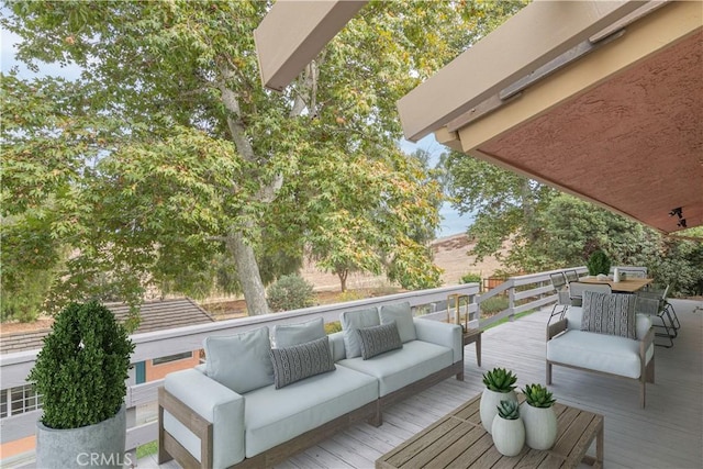 wooden terrace with an outdoor living space