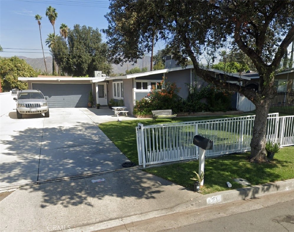 ranch-style home featuring a front yard and a garage