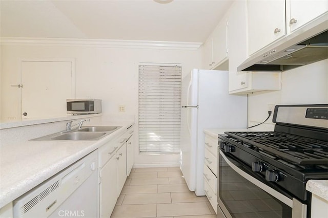 kitchen with appliances with stainless steel finishes, light tile patterned flooring, crown molding, white cabinets, and sink