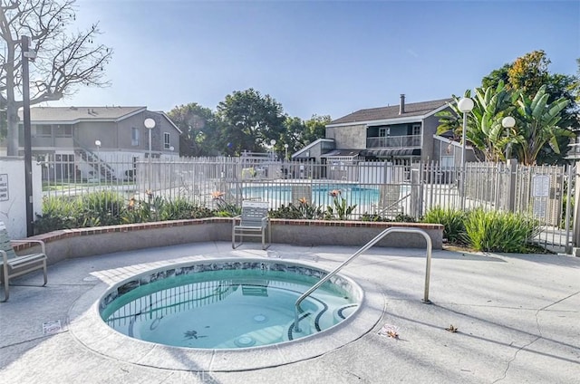 view of pool featuring a patio area and a community hot tub