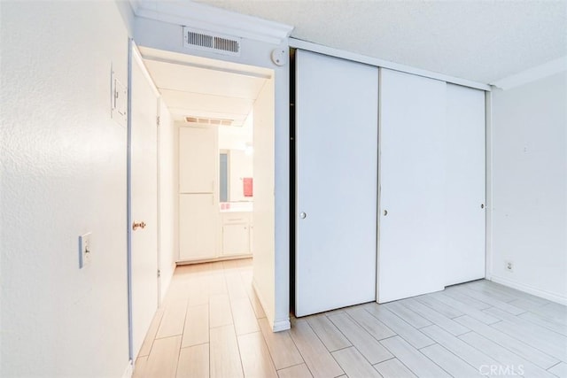 unfurnished bedroom featuring light hardwood / wood-style floors and a closet