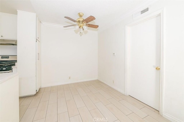 unfurnished room with ceiling fan and ornamental molding