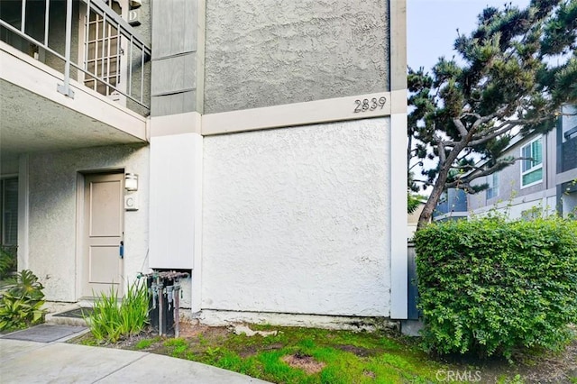 view of side of home featuring a balcony