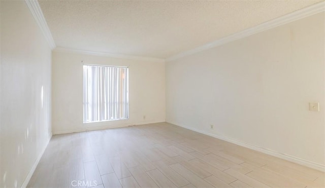 spare room featuring crown molding and light hardwood / wood-style floors