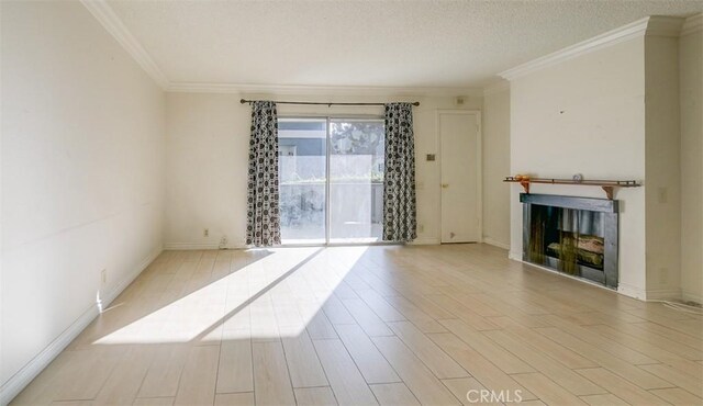 unfurnished living room featuring crown molding, a textured ceiling, and light hardwood / wood-style flooring