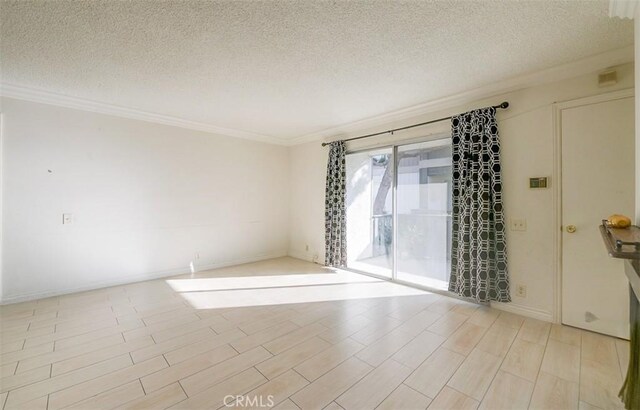 spare room with a textured ceiling and crown molding