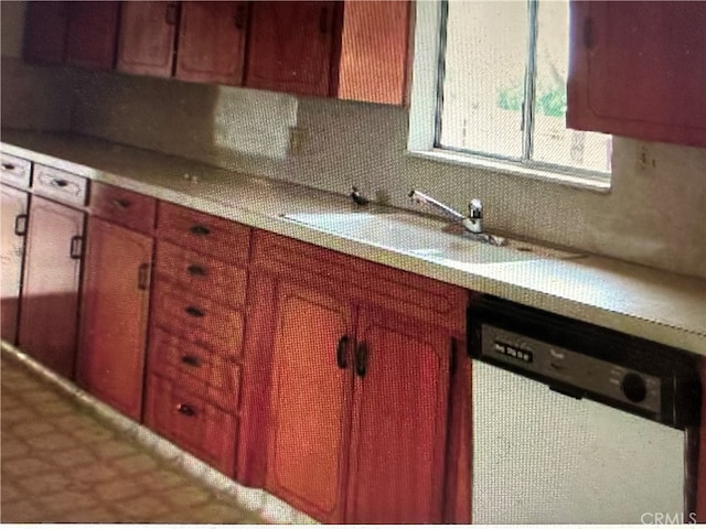 kitchen with dishwashing machine and backsplash