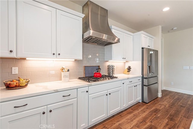 kitchen with white cabinetry, island exhaust hood, stainless steel appliances, and backsplash