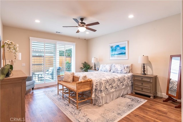 bedroom with hardwood / wood-style floors, ceiling fan, and access to exterior