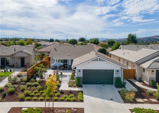 ranch-style house with driveway, a garage, a residential view, and fence