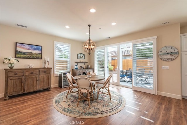 dining room featuring hardwood / wood-style flooring and a notable chandelier