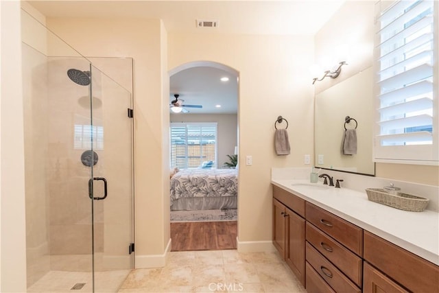 bathroom with ceiling fan, vanity, and a shower with shower door