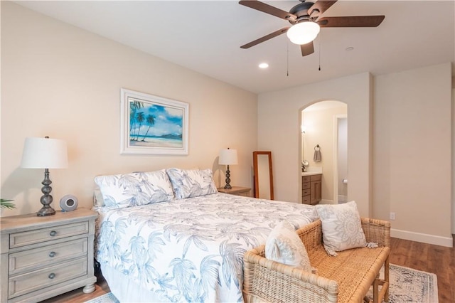 bedroom with ensuite bathroom, hardwood / wood-style floors, and ceiling fan