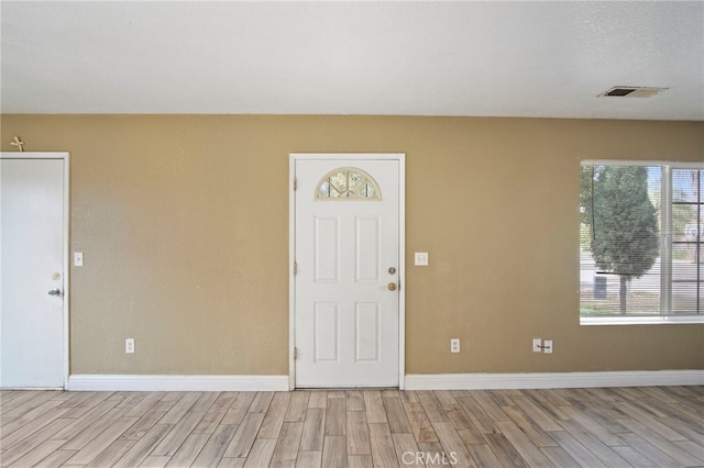 foyer entrance with light hardwood / wood-style flooring