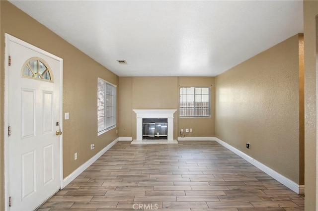 unfurnished living room featuring light hardwood / wood-style flooring