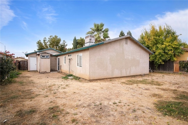 back of property with a shed