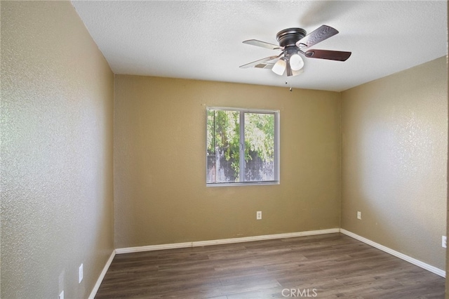 unfurnished room featuring ceiling fan, dark hardwood / wood-style flooring, and a textured ceiling