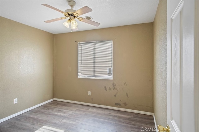 unfurnished room featuring ceiling fan and light hardwood / wood-style flooring