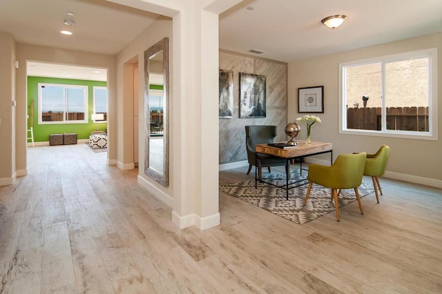 dining space with light hardwood / wood-style flooring