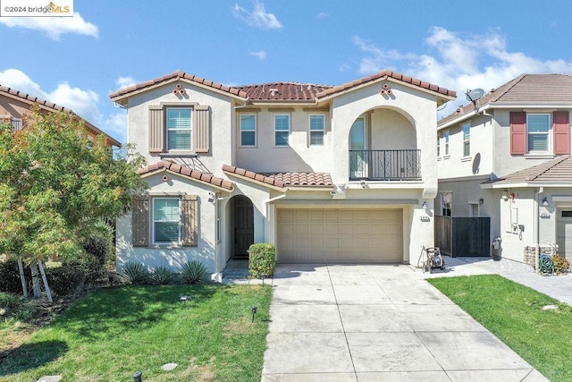 mediterranean / spanish-style house with a front yard and a garage