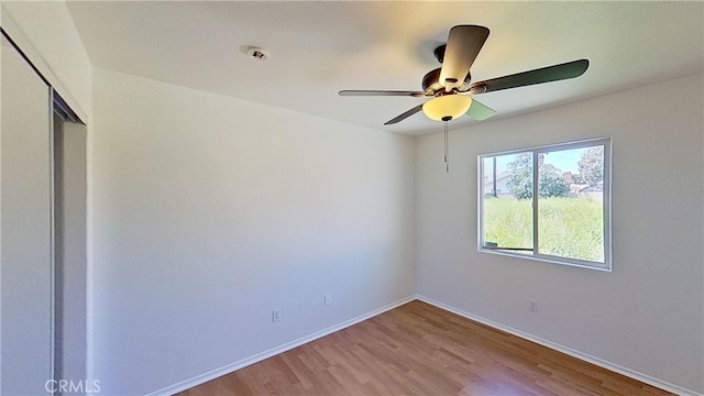 spare room featuring light hardwood / wood-style floors and ceiling fan