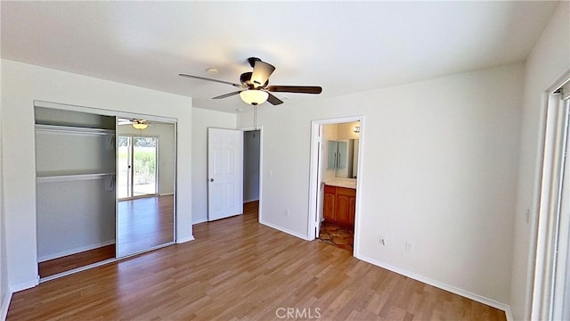 unfurnished bedroom featuring a closet, light hardwood / wood-style floors, and ceiling fan