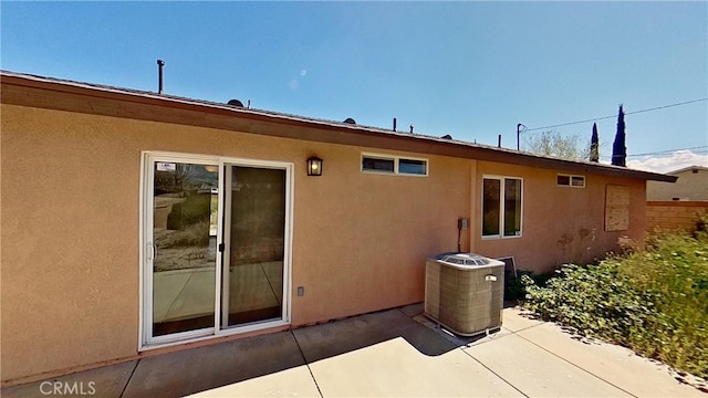 rear view of property with a patio area and central AC unit