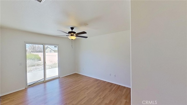 spare room with hardwood / wood-style flooring and ceiling fan