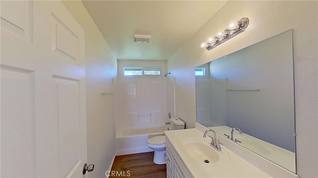 full bathroom with  shower combination, vanity, wood-type flooring, and toilet